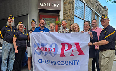 cc250 flag being held by people identified in text below