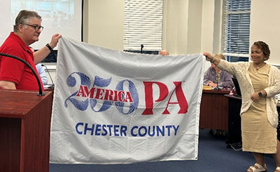 cc250 flag being held by people identified in text below