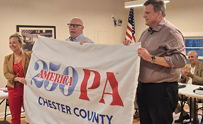 cc250 flag being held by people identified in text below