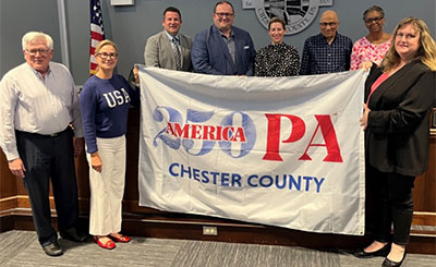 cc250 flag being held by people identified in text below