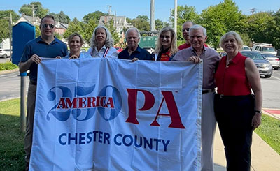 cc250 flag being held by people identified in text below