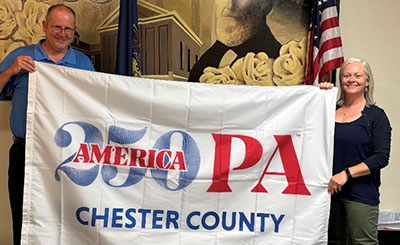cc250 flag being held by people identified in text below